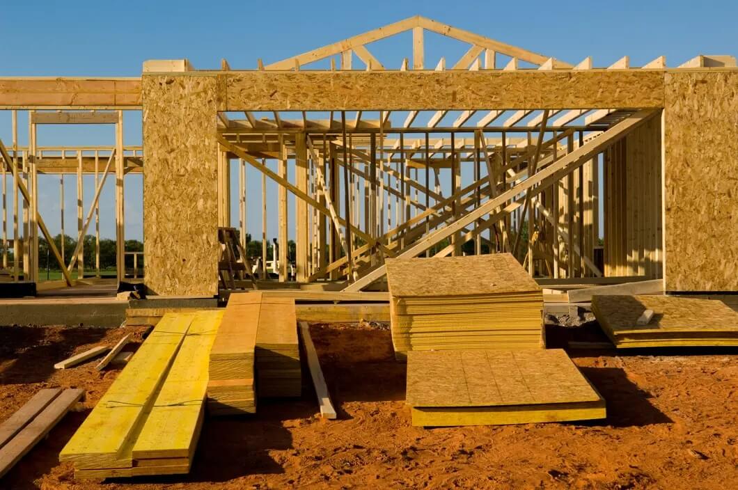 A building under construction with many wooden boards.